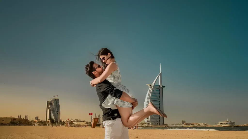 Couple posing on Jumeirah Beach with Burj Al Arab in background