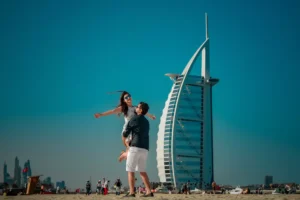 Couple posing on Jumeirah Beach with Burj Al Arab in background