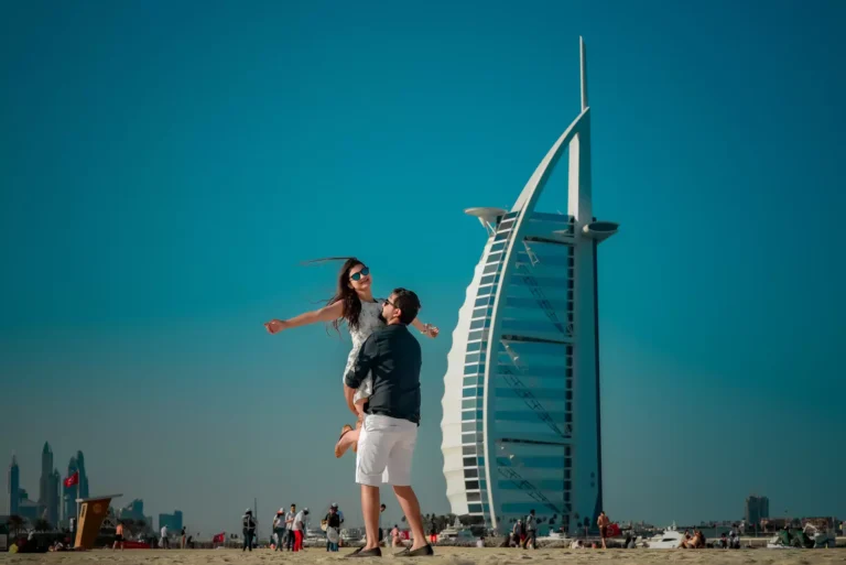 Couple posing on Jumeirah Beach with Burj Al Arab in background