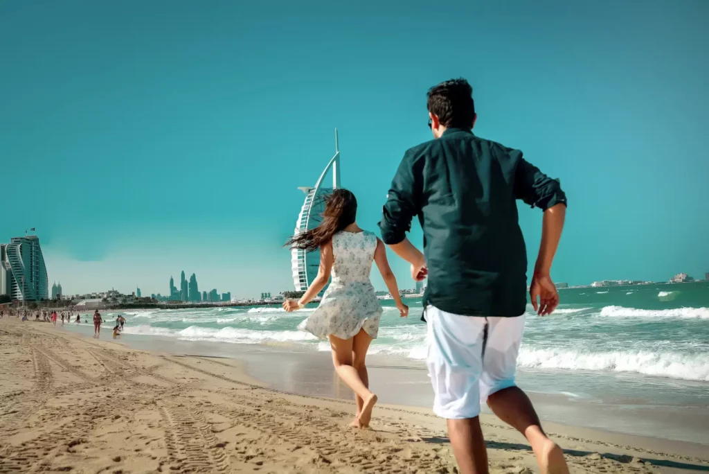 Couple beach running on Jumeirah Beach, Dubai