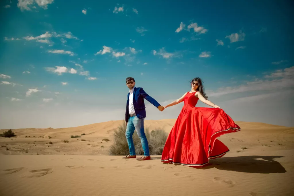 Couple posing on desert dunes, Dubai pre-wedding