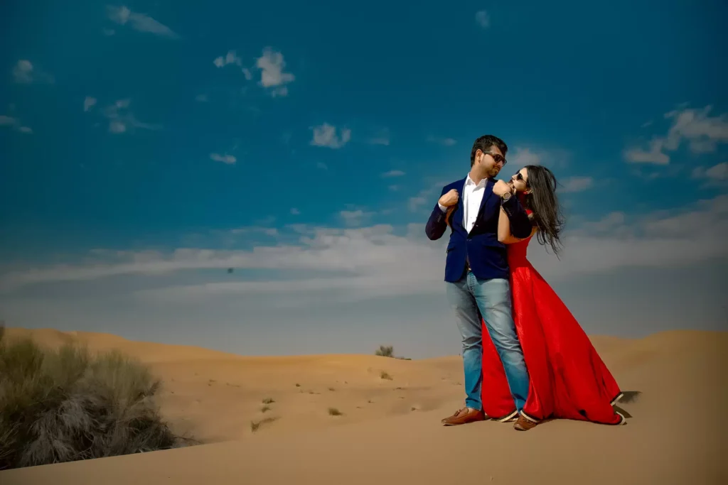 Couple exploring desert dunes, Dubai