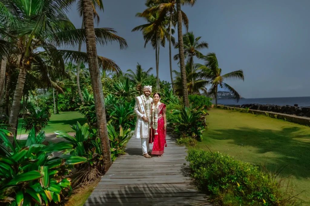 Couple portrait at Taj Green Cove Resort with greenery and seaside backdrop