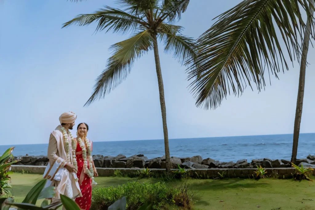 Bride and groom walking along the beach at Taj Green Cove