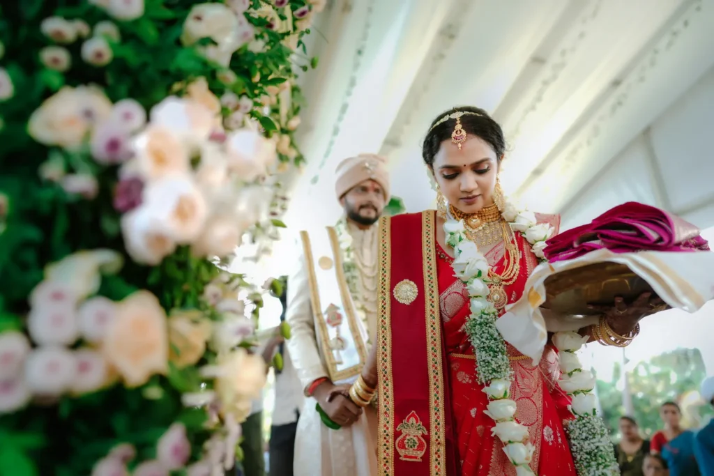 Bride and groom in traditional dress with sea view at Taj Green Cove