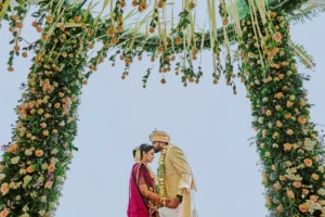 Bride and groom exchanging garlands at Leela Kovalam wedding