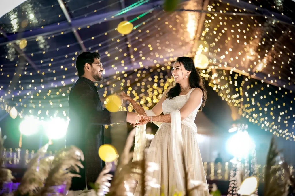 Bride and groom under floral decor at Trivandrum wedding